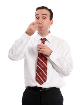 A young employee wearing a suit and tie is eating a container of yogurt, isolated against a white background