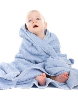 Crying baby sitting in a blue towel on white background