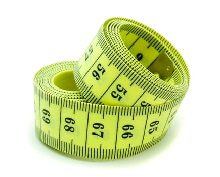 A coiled yellow measuring tape on white background