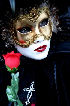 Masked lady with a rose during the Venice carnival, portrait,