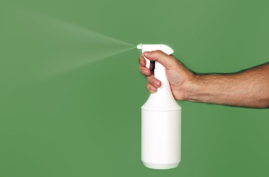 An image of a spray over green background