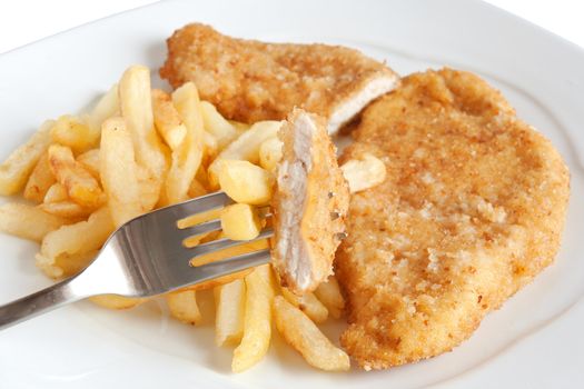 detail of fried potatoes and chicken with fork isolated on white background