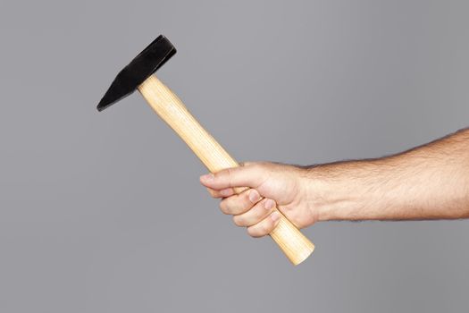 An image of a man holding a hammer