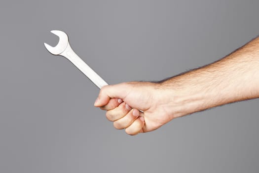 An image of a man holding a wrench