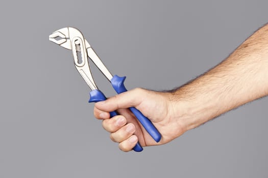 An image of a man holding pliers