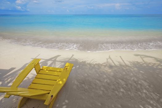 Wooden chair on a beautiful tropical beach 
