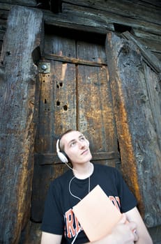 Man listening to the music in a park with white headphones