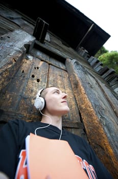 Man listening to the music in a park with white headphones