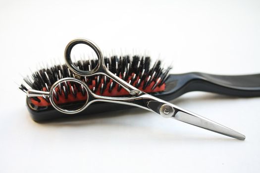 Basic hairdressers tools: pair of scissors and  a brush