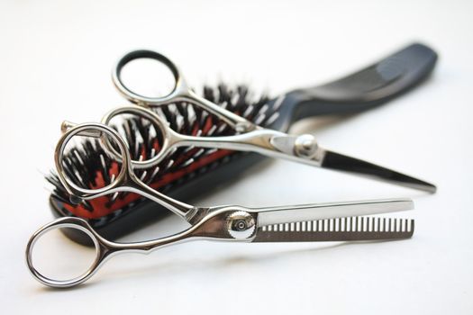 Basic hairdressers tools: two pairs of scissors and  a brush