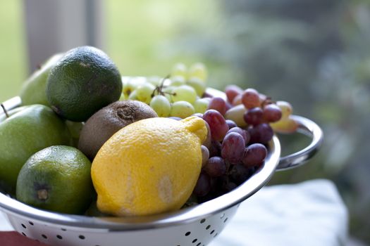 Colander of fresh fruit with shallow depth of field.