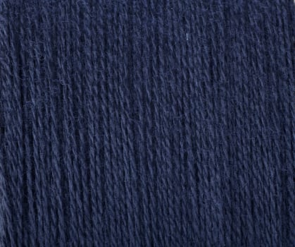 Dark blue threads ready for sewing or knitting.