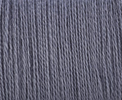 Grey threads ready for sewing or knitting.