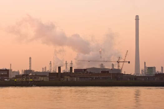 Industry and pollution on a misty morning at the riverside