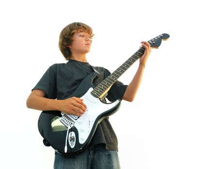 Teen boy playing electric guitar isolated over white.