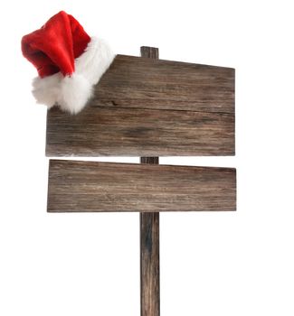 Weathered wooden sign with santa hat on white background