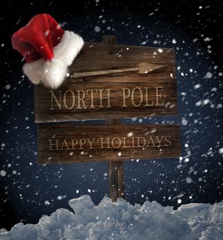 Weathered wooden sign with santa hat on snowy background
