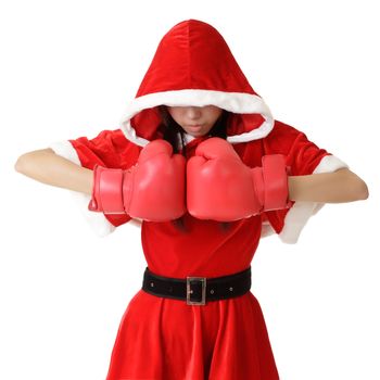 Christmas girl with boxing gloves posing over white background.