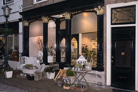 Florist shop in old building with enlightening and decoration on winter evening