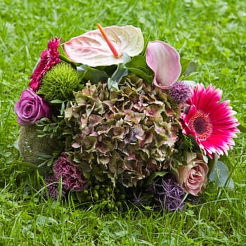 Bouquet with late summer flowers on grass background - square image
