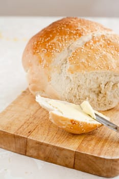 Freshly baked bread with butter and knife