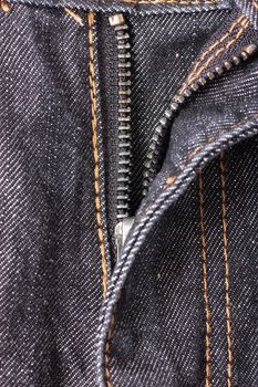 Closeup view of opened zipper on jeans.
