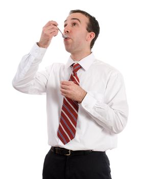 A young businessman eating a helathy snack of yogur, isolated against a white background