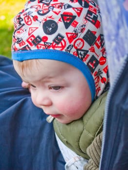 Innocent caucasian baby boy looking down at something