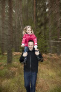 Father and his daughter in the forest