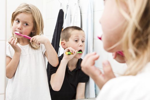 Siblings brushing teeths in the bathroom