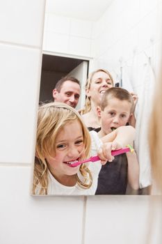 Family brushing teeths in the bathroom