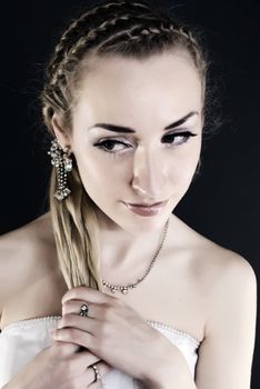 Young beautiful bride in wedding dress over black 