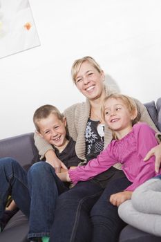 Mother in the sofa with her children
