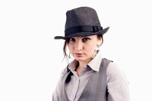 Portrait of a young beautiful seductive brunette in the hat