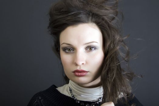 Portrait of a young beautiful brunette with the hair blowing about