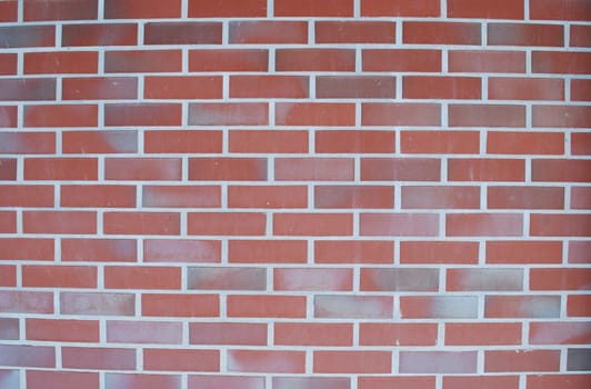 wall made of rectangular red bricks
