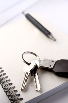 Diary, the handle and keys on a white background .