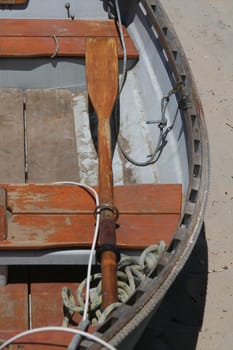 An old row boat on a white sand beach