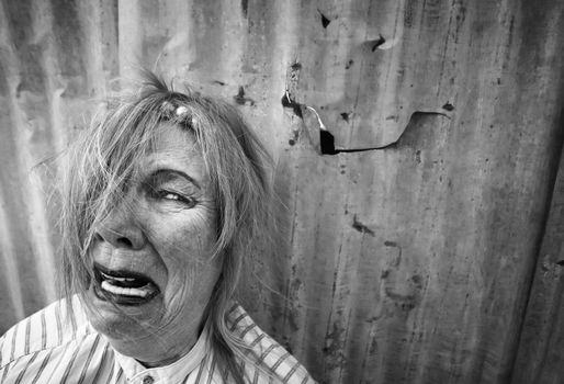 Senior homeless woman with too much makeup crying