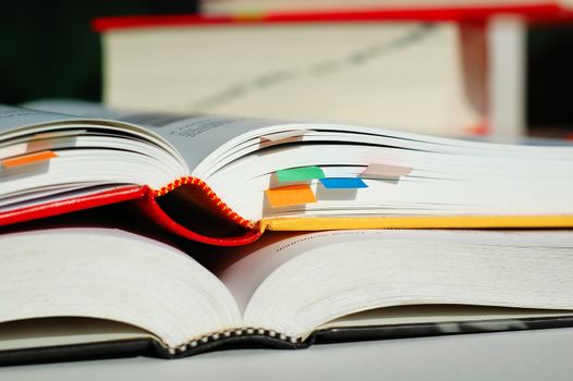 Two books are opened and piled together