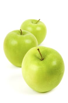 Three juicy green apple on a white background