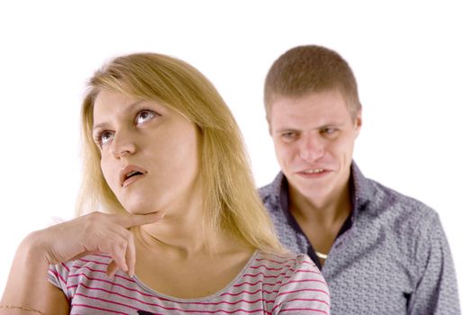 Young couple quarrel. A man in a rage, the woman is indifferent.
