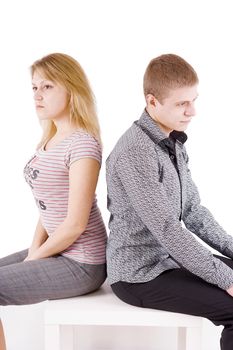 boy and girl sitting on a chair back to back
