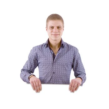 The happy young man on white background behind the white stand