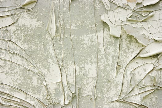 white and gray wall with old peeling paint
