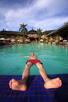 Man enjoying summer in the pool