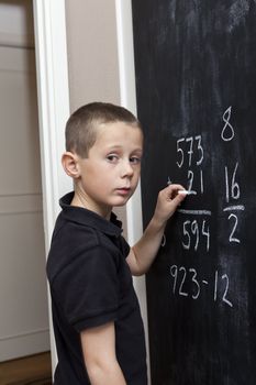 Young Boy in front of the blackboard