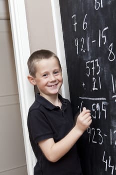 Young Boy in front of the blackboard at school