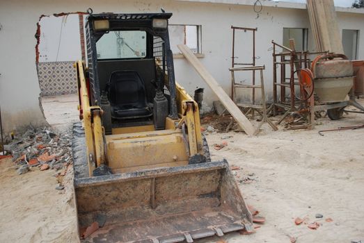 construction site with a yellow caterpillar to dig, carry and build