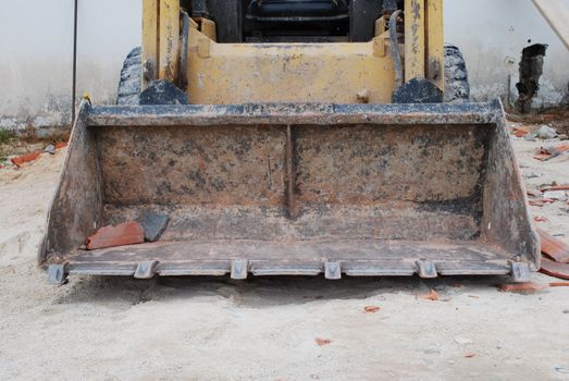 construction site with a yellow caterpillar to dig, carry and build